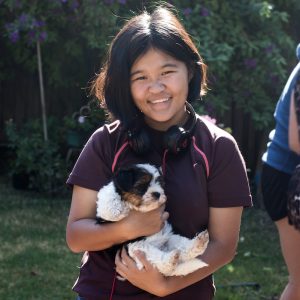 young woman holding a puppy